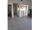 The living room opens to the kitchen and features tile floors, white walls, and natural light at 2981 Country Manor Ln # 118, Las Vegas, NV 89115
