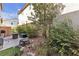 Private backyard featuring a gas grill, patio furniture, fire pit, and plenty of plants and shrubbery at 3132 Cartanda Ave, Henderson, NV 89044