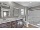 Modern bathroom with a double sink vanity, framed mirrors, and glass enclosed shower at 3132 Cartanda Ave, Henderson, NV 89044