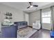 Cozy Bedroom with ceiling fan, a crib, changing table, and comfortable armchair at 3132 Cartanda Ave, Henderson, NV 89044
