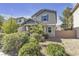 Charming two-story home with gray siding, front porch and landscaped yard, offering inviting curb appeal at 3132 Cartanda Ave, Henderson, NV 89044