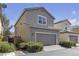 Charming two-story home features a gray exterior, a well-kept lawn, and a two-car garage at 3132 Cartanda Ave, Henderson, NV 89044