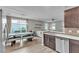 Open concept kitchen with stainless steel dishwasher and adjacent dining area at 3132 Cartanda Ave, Henderson, NV 89044