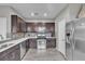Well-lit kitchen with stainless steel appliances and dark cabinets at 3132 Cartanda Ave, Henderson, NV 89044