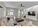 Comfortable living room with a large sectional sofa, TV, and staircase at 3132 Cartanda Ave, Henderson, NV 89044