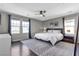 Spacious main bedroom with a ceiling fan, hardwood floors, and large windows for natural light at 3132 Cartanda Ave, Henderson, NV 89044