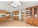 Spacious kitchen with wooden cabinets, laminate countertops, wood flooring, and modern lighting at 3250 Duneville St, Las Vegas, NV 89146