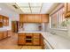 Kitchen with wood cabinets, laminate countertops, and stainless steel appliances at 3250 Duneville St, Las Vegas, NV 89146