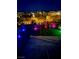An artistic backyard with colorful lighting and landscaping at 438 Wind Poppy St, Las Vegas, NV 89138