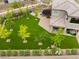 Aerial view of a well-manicured backyard featuring a play area, young trees and a covered patio at 438 Wind Poppy St, Las Vegas, NV 89138