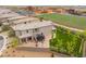 An aerial view of the backyard featuring artificial turf, a trampoline, trees and a patio area at 438 Wind Poppy St, Las Vegas, NV 89138