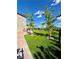 Expansive backyard features mature landscaping, new trees and artifical turf at 438 Wind Poppy St, Las Vegas, NV 89138