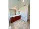 Bright bathroom features a double vanity with dark wood cabinets, a large mirror, and neutral tile flooring at 438 Wind Poppy St, Las Vegas, NV 89138