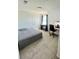 Simple bedroom with carpet, an unmade bed and a small workstation at 438 Wind Poppy St, Las Vegas, NV 89138