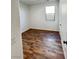 Empty bedroom with wood-look flooring, neutral walls, and a bright window at 438 Wind Poppy St, Las Vegas, NV 89138