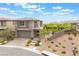 Charming two-story home featuring a brick driveway, two-car garage, and landscaped front yard with desert landscaping at 438 Wind Poppy St, Las Vegas, NV 89138