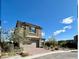 Beautiful two-story home showcasing a neutral color, complemented by a brick driveway and desert landscaping at 438 Wind Poppy St, Las Vegas, NV 89138
