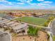 Aerial view of a single-Gathering home across from a school, featuring a well-manicured backyard at 438 Wind Poppy St, Las Vegas, NV 89138