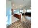 Open-concept living space featuring a kitchen island, stainless steel appliances, and hardwood floors at 438 Wind Poppy St, Las Vegas, NV 89138