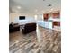 Open concept living space featuring modern decor, hardwood floors, and a large kitchen island at 438 Wind Poppy St, Las Vegas, NV 89138