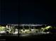 Distant city skyline at night, with neighborhood in foreground at 438 Wind Poppy St, Las Vegas, NV 89138