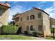 Charming condo building featuring a red tile roof and lush green landscaping at 4720 Obannon Dr # D, Las Vegas, NV 89102