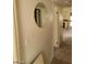 Hallway with round mirror and view into a room with a fireplace at 4720 Obannon Dr # D, Las Vegas, NV 89102