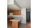 Traditional-style kitchen with tiled floors, breakfast bar, and wood cabinets at 4720 Obannon Dr # D, Las Vegas, NV 89102