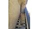 Exterior staircase leading to condo units with railing, blue accents, and greenery nearby at 4720 Obannon Dr # D, Las Vegas, NV 89102