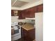 A kitchen features a white oven, dark cabinets and light counter tops at 4770 Topaz St # 79, Las Vegas, NV 89121
