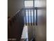 Classic wooden staircase leads to upper level, offering a view of the entryway and natural light at 4770 Topaz St # 79, Las Vegas, NV 89121