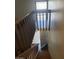 Well-lit staircase with wooden handrails and a window landing area at 4770 Topaz St # 79, Las Vegas, NV 89121