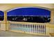 An outdoor patio offers stunning views of the city skyline at night from it's elevated vantage point at 5030 Spanish Hills Dr, Las Vegas, NV 89148