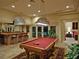 Entertaining game room with pool table, bar area, and outdoor access at 5030 Spanish Hills Dr, Las Vegas, NV 89148