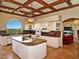 Bright kitchen featuring granite counters, an island, and modern appliances at 5030 Spanish Hills Dr, Las Vegas, NV 89148