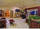 An open living room features a stone fireplace and a balcony with city views at 5030 Spanish Hills Dr, Las Vegas, NV 89148