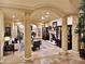 Elegant living room featuring tile floors, marble columns, and fireplace at 5030 Spanish Hills Dr, Las Vegas, NV 89148