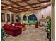Cozy living room with fireplace, stone accents, and pool views at 5030 Spanish Hills Dr, Las Vegas, NV 89148