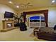 A spacious main bedroom features a fireplace and a balcony offering stunning views of the city skyline at 5030 Spanish Hills Dr, Las Vegas, NV 89148