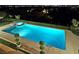 A private outdoor pool features a spa, a pool deck, and mature landscaping, offering a tranquil backyard retreat at 5030 Spanish Hills Dr, Las Vegas, NV 89148
