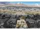Scenic aerial view of a neighborhood, showcasing mountain views, lush landscaping, and a private pool at 516 Pinnacle Heights Ln, Las Vegas, NV 89144