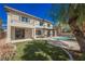 Spacious backyard with lush lawn, sparkling pool, and covered patio, perfect for entertaining and relaxation at 516 Pinnacle Heights Ln, Las Vegas, NV 89144