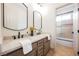 Bathroom with double sinks, framed mirrors and a view of the tub/shower combination at 516 Pinnacle Heights Ln, Las Vegas, NV 89144