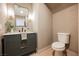 Chic powder room with a modern vanity, stylish mirror, and elegant wall sconces at 516 Pinnacle Heights Ln, Las Vegas, NV 89144