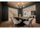 Elegant dining room with dark walls, herringbone ceiling, and a modern chandelier at 516 Pinnacle Heights Ln, Las Vegas, NV 89144