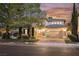 Charming home exterior showcases a manicured lawn, paved driveway, and a secure gated entry for added privacy at 516 Pinnacle Heights Ln, Las Vegas, NV 89144