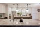 Beautiful kitchen with an island, stainless steel appliances, and stylish hanging lights at 516 Pinnacle Heights Ln, Las Vegas, NV 89144