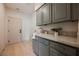 Well-lit laundry room with ample storage, stylish cabinetry, and quartz countertops at 516 Pinnacle Heights Ln, Las Vegas, NV 89144