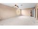 Spacious bedroom featuring neutral walls, carpet, ceiling fan and a window at 5615 Calais Ct, Las Vegas, NV 89118