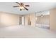 Spacious bedroom with neutral carpet, ceiling fan, and mirrored closet doors at 5615 Calais Ct, Las Vegas, NV 89118